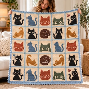 May include: A square crochet blanket featuring a grid of twenty-five cream-colored squares, each displaying a cat motif in black, blue, orange, green, or brown. The blanket is bordered by a light blue scalloped edge and light blue grid lines.