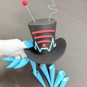 Puede incluir: Un sombrero de copa negro con detalles rojos y azules, con un diseño de símbolo Wi-Fi. Dos esferas rojas están unidas a la parte superior con antenas de alambre blanco. El sombrero es sostenido por una mano con garras azules y conos azules.