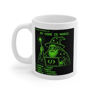 May include: A white ceramic mug featuring a black square graphic with bright green text and a wizard illustration. The text reads: developer@localhost:~$ MY CODE IS MAGIC, followed by lines for coffee, code, build, and deploy with command-line syntax.