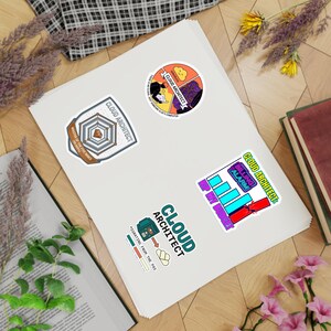 May include: A selection of vibrant stickers, all themed around "CLOUD ARCHITECT". Designs include a cloud, a person at a computer, and a bar graph labeled "BILLING ALARM". The stickers are on a white surface.