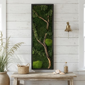 May include: A rectangular wall art piece featuring a dark frame filled with preserved green moss and a central curved wooden branch. The moss displays varying shades of deep forest green and bright lime green, creating a textured, organic surface.