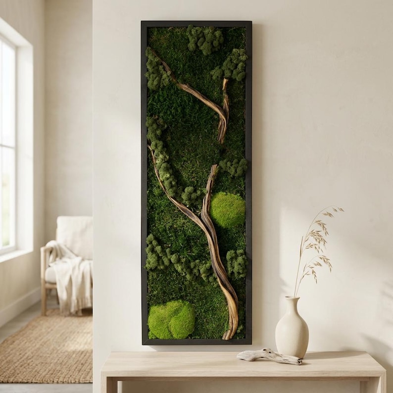 May include: A vertical rectangular wall art piece featuring a black frame filled with preserved green moss and natural driftwood branches. The composition includes various textures of deep forest green and bright lime green moss clusters.