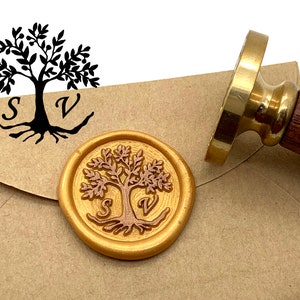 May include: A gold wax seal with a tree design and the letters "S" and "V" is pressed onto a brown envelope. A brass and wood handled stamp is next to the seal. The tree design is also printed in black on the envelope.
