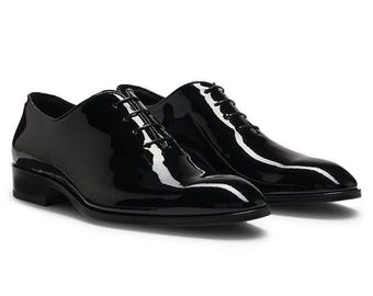 Handmade Men's Black Patent Leather Oxford Shoes are crafted in a whole-cut style,.