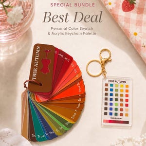 May include: A personal color swatch fan labeled True Autumn featuring various shades of red, orange, brown, green, and blue, paired with a rectangular acrylic keychain palette displaying a grid of True Autumn makeup colors and a gold keyring.