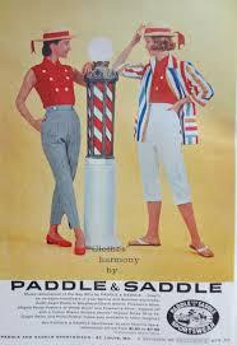 May include: Vintage fashion advertisement featuring two women in stylish outfits. One wears a red top and gray pants, the other a red top and white capri pants. Both wear matching hats. A barber pole stands between them. The ad includes the text "Clothes by Harmony" and "Paddle & Saddle".