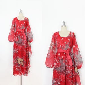 May include: A red maxi dress with a floral print and long sleeves. The dress has a gathered waist and a flowing skirt.