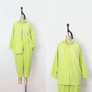 Puede incluir: Un conjunto de pijama de felpa verde lima con una camisa de botones y pantalones a juego.