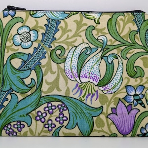 May include: A beige zippered pouch with a floral pattern in shades of green, blue, purple, and white. The pattern features stylised flowers and leaves.