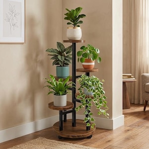 May include: A multi-tiered plant stand with five levels, each holding a potted plant. The stand has a dark metal frame and round, wooden shelves. The plants include a fiddle-leaf fig, a prayer plant, and a trailing vine.