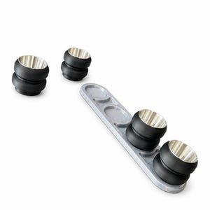 May include: A set of four black and silver coasters with a matching gray serving tray. The coasters have a stacked design with a silver interior. The tray has three circular indentations to hold the coasters.