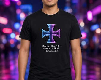 May include: A black short-sleeved t-shirt featuring a glowing purple and blue cross graphic centered on the chest. Below the cross, the text reads: Put on the full armor of God. — Ephesians 6:11. The shirt has a crew neckline.