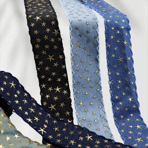 1.	Denim ribbon with embossed star pattern 
2.	Vintage washed denim ribbon for DIY crafts 
3.	3D star textured ribbon close-up 
4.	Blue jean ribbon with decorative edge trim 
5.	Black denim ribbon for fashion accessories 
6.	Textured ribbon for hair bow making 
7.	Assorted denim ribbons in multiple shades 
8.	Fabric ribbon for clothing embellishment 
9.	Stylish denim trim for handmade projects 
10.	Wide denim ribbon rolls for crafts