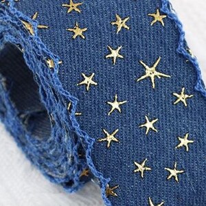 1.	Denim ribbon with embossed star pattern 
2.	Vintage washed denim ribbon for DIY crafts 
3.	3D star textured ribbon close-up 
4.	Blue jean ribbon with decorative edge trim 
5.	Black denim ribbon for fashion accessories 
6.	Textured ribbon for hair bow making 
7.	Assorted denim ribbons in multiple shades 
8.	Fabric ribbon for clothing embellishment 
9.	Stylish denim trim for handmade projects 
10.	Wide denim ribbon rolls for crafts