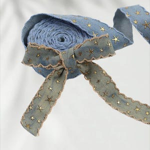 1.	Denim ribbon with embossed star pattern 
2.	Vintage washed denim ribbon for DIY crafts 
3.	3D star textured ribbon close-up 
4.	Blue jean ribbon with decorative edge trim 
5.	Black denim ribbon for fashion accessories 
6.	Textured ribbon for hair bow making 
7.	Assorted denim ribbons in multiple shades 
8.	Fabric ribbon for clothing embellishment 
9.	Stylish denim trim for handmade projects 
10.	Wide denim ribbon rolls for crafts