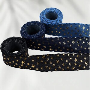 1.	Denim ribbon with embossed star pattern 
2.	Vintage washed denim ribbon for DIY crafts 
3.	3D star textured ribbon close-up 
4.	Blue jean ribbon with decorative edge trim 
5.	Black denim ribbon for fashion accessories 
6.	Textured ribbon for hair bow making 
7.	Assorted denim ribbons in multiple shades 
8.	Fabric ribbon for clothing embellishment 
9.	Stylish denim trim for handmade projects 
10.	Wide denim ribbon rolls for crafts