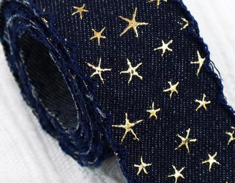 1.	Denim ribbon with embossed star pattern 
2.	Vintage washed denim ribbon for DIY crafts 
3.	3D star textured ribbon close-up 
4.	Blue jean ribbon with decorative edge trim 
5.	Black denim ribbon for fashion accessories 
6.	Textured ribbon for hair bow making 
7.	Assorted denim ribbons in multiple shades 
8.	Fabric ribbon for clothing embellishment 
9.	Stylish denim trim for handmade projects 
10.	Wide denim ribbon rolls for crafts