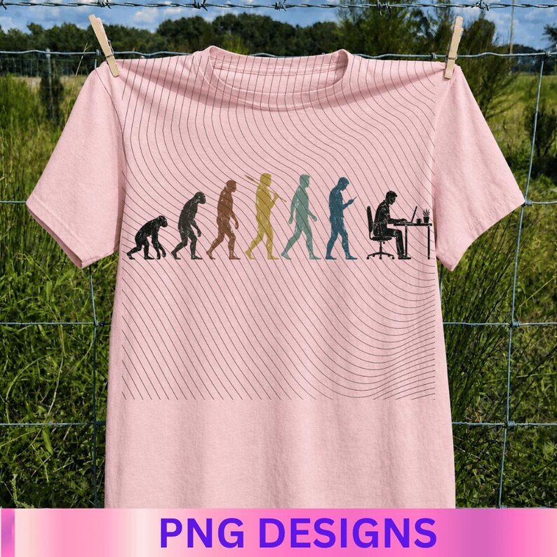 May include: A light pink t-shirt featuring a graphic print of human evolution, progressing from a primate to a person sitting at a desk with a laptop. The design is overlaid with thin, wavy black lines that span across the center of the shirt.