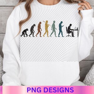 May include: A white long-sleeve sweatshirt featuring a graphic print of human evolution, starting from a primate and progressing to a person sitting at a desk with a computer. The background of the graphic consists of thin, wavy black lines.