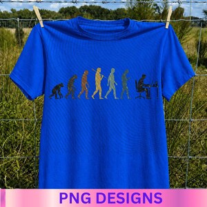 May include: A bright blue short-sleeved t-shirt featuring a graphic print of the evolution of humanity. The design shows a series of figures progressing from a primate to a human sitting at a desk working on a computer, rendered in muted colors.
