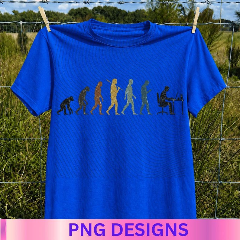 May include: A bright blue short-sleeved t-shirt featuring a graphic print of the evolution of humanity. The design shows a series of figures progressing from a primate to a human sitting at a desk working on a computer, rendered in muted colors.