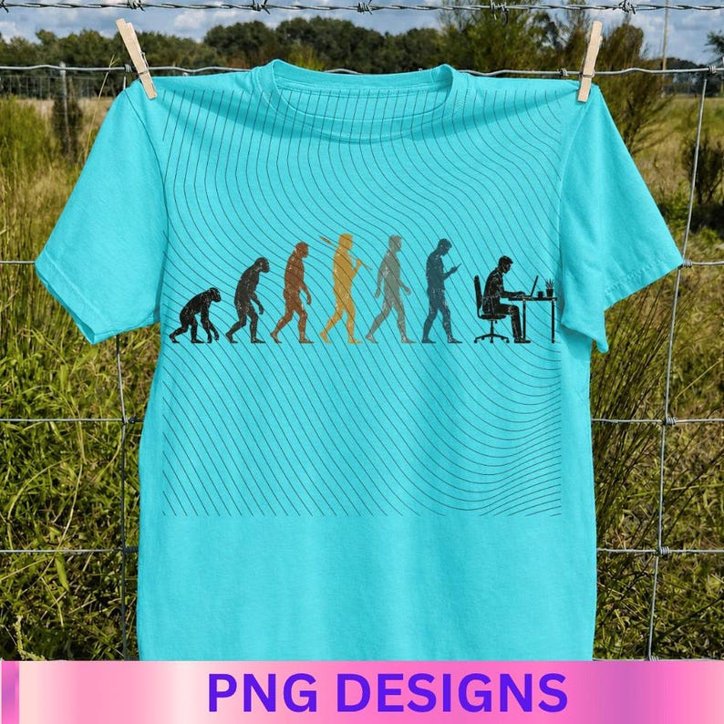 May include: A bright turquoise t-shirt featuring a black graphic print that depicts the evolution of humanity, starting from a primate and progressing to a person sitting at a desk with a computer. The design includes subtle wavy line patterns.