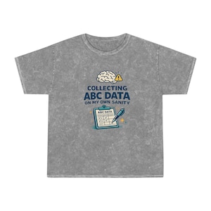 May include: Gray t-shirt with a graphic that reads "COLLECTING ABC DATA ON MY OWN SANITY." The design includes a brain, a clipboard with checkmarks, and a pen. The shirt is made of a soft, comfortable material.