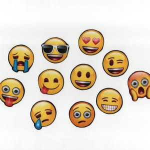 May include: A collection of yellow emoji stickers with various facial expressions. Some emojis have sunglasses, hearts for eyes, or tears. Others show a tongue sticking out, a winking face, and a toothy grin. The stickers are on a white background.
