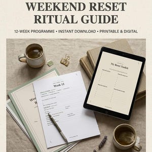 May include: A 12-week weekend reset ritual guide by The Lazy Sunday Club, featuring a digital tablet displaying a My Reset Toolkit page, printed weekly planner sheets, a silver pen, two ceramic mugs with tea, and a gold binder clip.