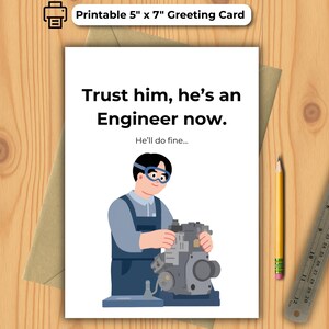 May include: A 12.7cm x 17.8cm greeting card with the text "Trust him, he's an Engineer now." An illustration shows an engineer working on a machine. A pencil and ruler are on the wooden surface.