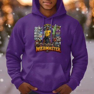May include: A purple hooded sweatshirt featuring a graphic print of a character holding a glowing green sword and a shield. The design includes various icons, text labels like BUGS, GLITCHES, and the word WEBMASTER in large yellow letters at the bottom.