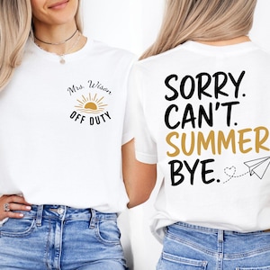 May include: A white t-shirt featuring a small graphic on the front left chest with a sun icon and the text Mrs. Wison OFF DUTY. The back of the shirt displays the large black and gold text SORRY. CAN'T. SUMMER. BYE. with a paper airplane icon.