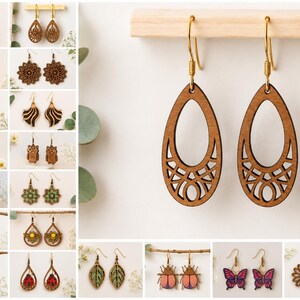 May include: A pair of teardrop-shaped wooden earrings with a laser-cut geometric lattice pattern at the base. The earrings feature gold-toned metal fishhook wires and are suspended from a horizontal wooden bar for display purposes.