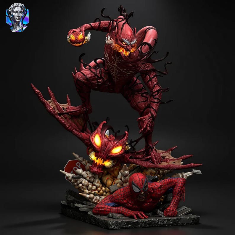 May include: A detailed statue featuring the Marvel Comics character Carnage in a dynamic pose, with a red and black color scheme. The statue includes Spider-Man and a demonic creature with glowing eyes, set on a rocky base.