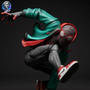 May include: A dynamic figurine of a superhero in a crouching pose. The figure wears a red and black mask, a green jacket with a red lining, and gray pants. The shoes are red and white. The overall aesthetic is a stylized, action-oriented design.