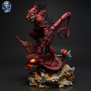 May include: A detailed red and black figurine of a comic book character in a dynamic pose. The figure has a menacing expression and is perched atop a creature with glowing orange eyes. The base features a rocky, cloud-like texture.