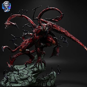 May include: A detailed figurine of the Marvel Comics character Carnage, posed on a rocky base. The figure is predominantly red with black tendrils and accents, showcasing intricate textures and dynamic posing. The statue is a collectible item.