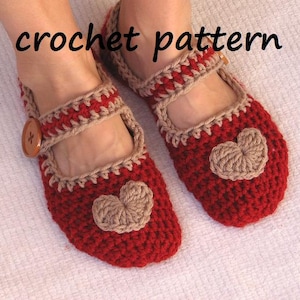 May include: Red crochet slippers with a brown heart design and a brown button. The slippers are made with a crochet stitch and have a simple, classic design.