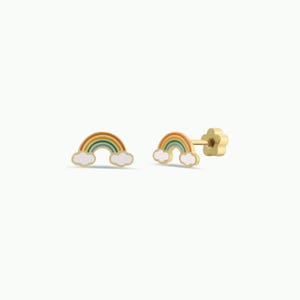 May include: Gold-colored rainbow stud earrings with white cloud accents. The rainbow design features orange, yellow, green, and blue stripes. The earring posts have a flower-shaped backing.