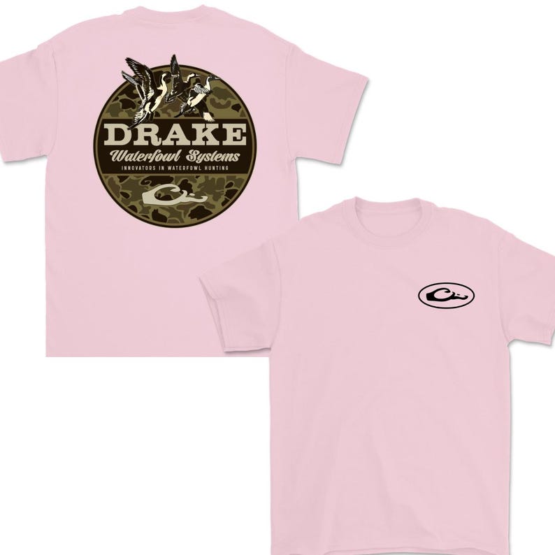 May include: Light pink t-shirts with a crew neck. One shirt features a circular design on the back with the text "DRAKE Waterfowl Systems" and a duck graphic. The other shirt has a small oval logo on the front.