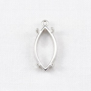 May include: A silver-toned marquise-shaped pendant setting featuring a smooth, polished metal frame with a small circular loop at the top for attachment and four small prongs positioned along the sides to secure a gemstone or insert.