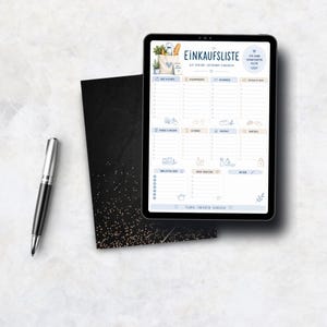 May include: A digital tablet displaying a grocery shopping list titled Einkaufsliste with categories for food, drinks, and household items, accompanied by a black and gold glitter notebook and a silver and black ballpoint pen.
