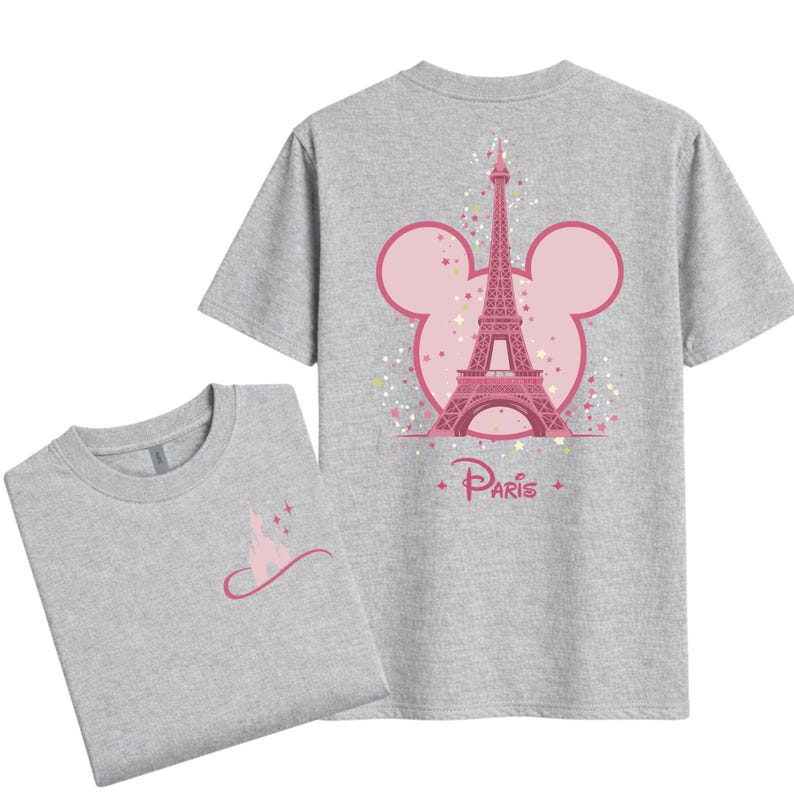 May include: Two gray t-shirts. One shirt features a pink Eiffel Tower design within a Mickey Mouse head outline, with the word "Paris" below. The other shirt has a pink castle design.