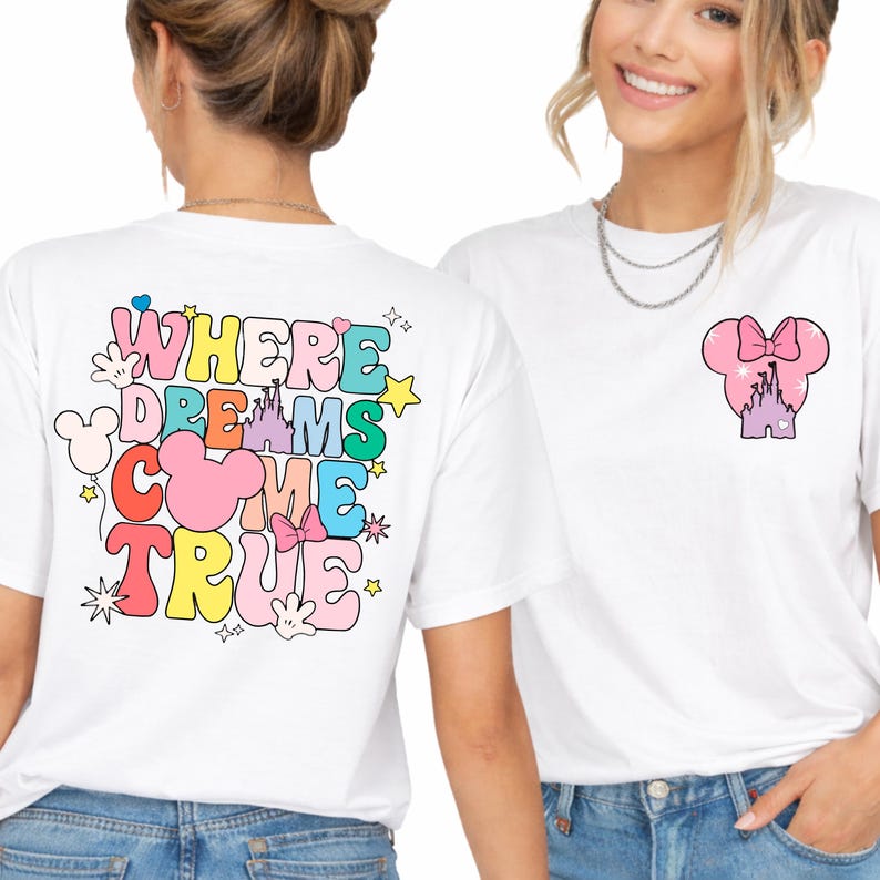 May include: White t-shirts with colourful graphics. One shirt features the text "WHERE DREAMS COME TRUE" with Mickey Mouse ears and stars. The other shirt has a Minnie Mouse head with a castle design.