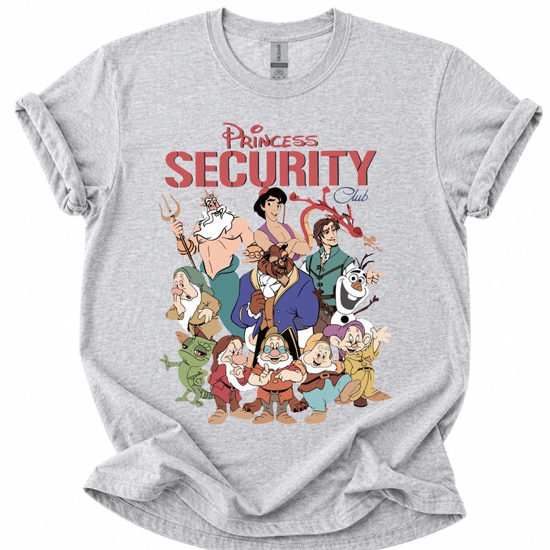 May include: A light grey t-shirt with a graphic of Disney characters. The text "Princess Security Club" is printed in red above the characters. The characters include the Beast, Olaf, and the Seven Dwarfs.