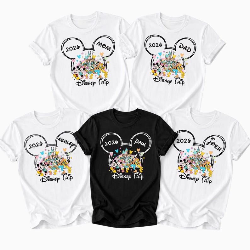 May include: A selection of white and black t-shirts with a Disney theme. Each shirt displays a Mickey Mouse ear design with the year "2026" and the names "Mom", "Dad", "Ashley", "Paul", and "Josh". The shirts also have a colourful Disney castle graphic and the words "Disney Trip".
