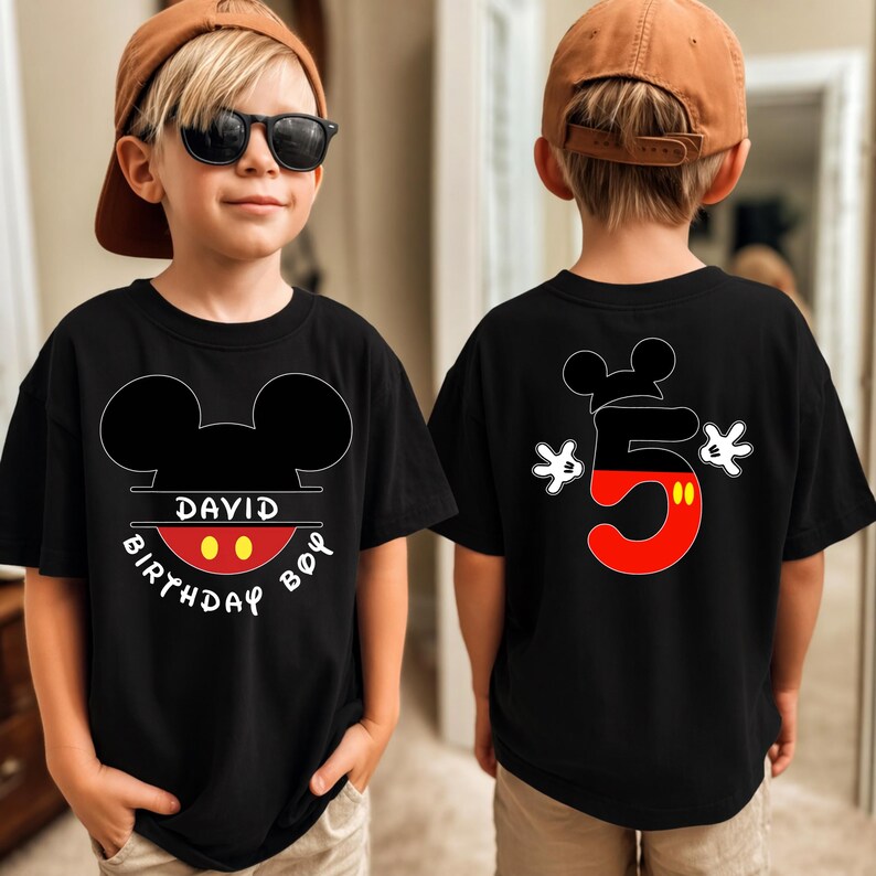 May include: Black t-shirt with a Mickey Mouse design. The front features Mickey Mouse ears, the name "DAVID", and the words "BIRTHDAY BOY". The back displays a large number "5" in red and black, with Mickey Mouse gloves.
