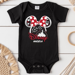 May include: Black baby bodysuit with a Minnie Mouse design. The design features a red polka dot bow, the word "Disney" in red script, and the name "Angela". The year "2020" is also included in the design.
