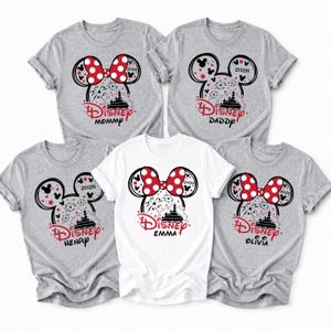 May include: Five gray and white t-shirts with a Disney theme. Each shirt features a Minnie Mouse design with a red bow, fireworks, and the word "Disney". The shirts are labeled "Mommy", "Daddy", "Henry", "Emma", and "Olivia".