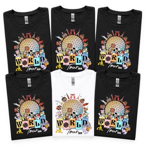 May include: Several black and white t-shirts with a vibrant graphic. The design showcases a large sphere, international landmarks, and cartoon characters. The text "WORLD Tour 2026" is included in the design.